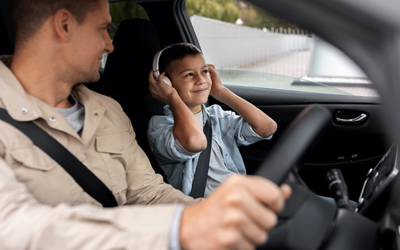 older kid watching their dad drive, road trip safety, December 2024, Australia